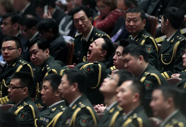 A military band member yawns during the opening session of the National People's Congress (NPC) at the Great Hall of the People in Beijing March 5, 2014. (Photo by Barry Huang/Reuters)