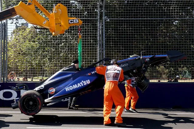 Marshals remove Williams' Thai driver Alexander Albon crashed car from the circuit during the first practice session of the Formula One Australian Grand Prix at the Albert Park Circuit in Melbourne on March 22, 2024. (Photo by Martin Keep/AFP Photo)