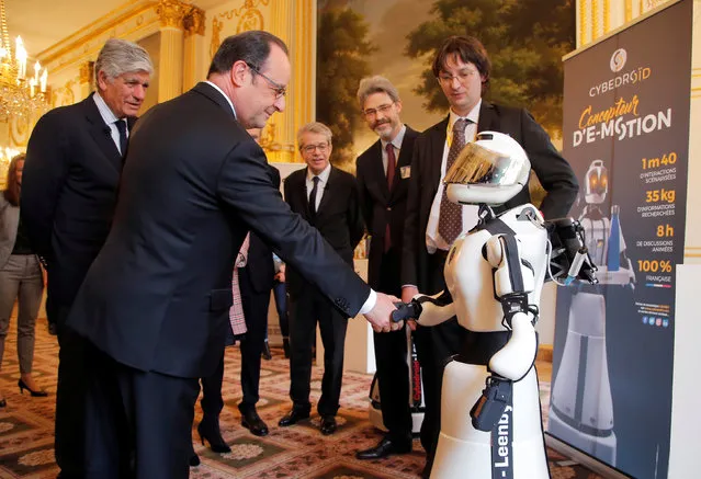French President Francois Hollande (L) shakes hands with Leenby, a Cybedroid robot, during the global tech conference Viva Technology at the Elysee Palace in Paris, France, February 21, 2017. (Photo by Michel Euler/Reuters)