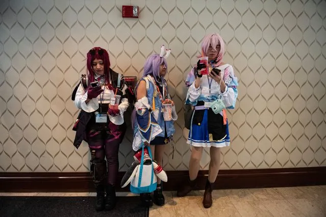 Cosplayers take a break from the convention to check their phones and get coffee during “Anime Boston 2024” at the Hynes Convention Center in Boston, Massachusetts, on March 30, 2024. The convention is organized by the New England Anime Society and celebrates all things Japanese animation, comics and popular culture. (Photo by Joseph Prezioso/AFP Photo)