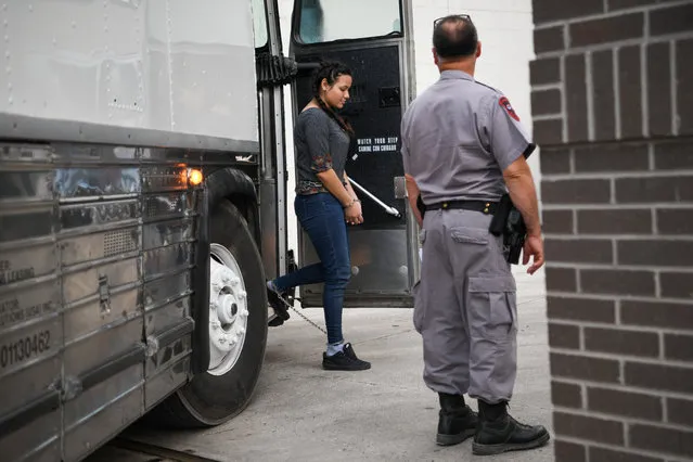 A shackled migrant woman in federal custody arrives for an immigration hearing at the U.S. federal courthouse in McAllen, Texas, U.S., May 20, 2019. (Photo by Loren Elliott/Reuters)