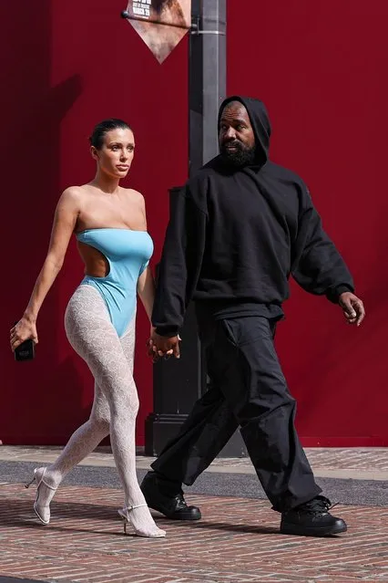 Rapper Kanye West and his wife Bianca Censori walk hand in hand while enjoying a movie theater date at the Grove in Los Angeles on March 24, 2024. Bianca rocked a strapless blue cutout bodysuit with her signature white lace tights underneath as the married couple venture out to catch “Dune 2” in theaters. (Photo by Backgrid USA)