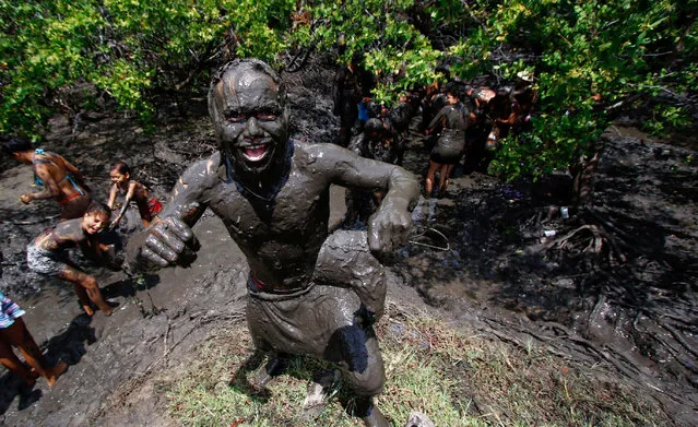 A reveller is pictured after covering himself with mud from the Redinha mangrove swamps as he celebrates Carnival at the annual block party known as “Os Cao” (The Dog) in Redinha in Rio Grande do Norte state, northeastern Brazil, February 28, 2017. (Photo by Nuno Guimaraes/Reuters)