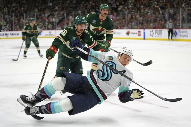 Minnesota Wild right wing Mats Zuccarello (36) trips Seattle Kraken center Yanni Gourde, front, during the second period of an NHL hockey game Thursday, April 18, 2024, in St. Paul, Minn. Zuccarello was penalized for tripping. (Photo by Abbie Parr/AP Photo)