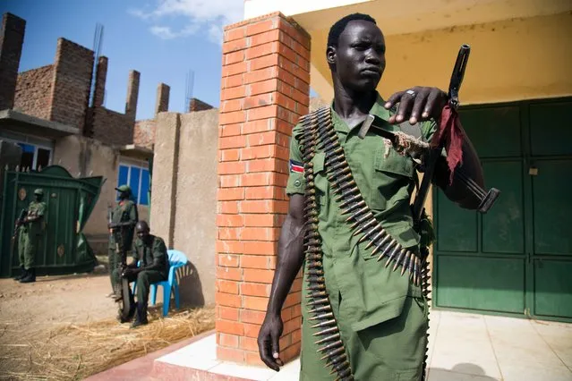 A member of the Sudan People's Liberation Army in Opposition (SPLA-IO) stand guard at the military site in Juba, after the arrival of new troops and their chief of staff on April 25, 2016. Rebel spokesman William Ezekiel said that 195 troops landed along with South Sudan's top rebel military commander Simon Gatwech Dual, to provide security for Machar, who he said hoped to return on April 26. Some of the rebel troops looked visibly nervous, but others were more cheerful and raised fists into the air as their leader shouted “Viva SPLA, viva SPLM!” – the acronym for the army and ruling party divided by the war. (Photo by Albert Gonzalez Farran/AFP Photo)