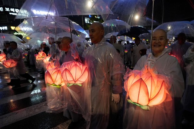 Buddhist monks walk in a lantern parade during the Lotus Lantern Festival, ahead of the birthday of Buddha at Dongguk University in Seoul, South Korea, Saturday, May 11, 2024. (Photo by Ahn Young-joon/AP Photo)