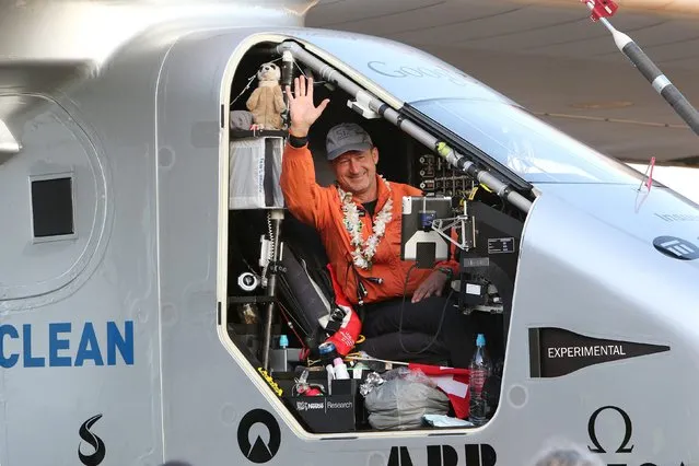 Pilot Andre Borschberg waves to the crowd after he landed the Solar Impulse 2 airplane at Kalaeloa airport after flying non-stop from Nagoya, Japan in Kapolei, Hawaii, July 3, 2015. The aircraft, powered only by the sun's energy and piloted alternatively by Swiss explorers Borschberg and Bertrand Piccard, has broken a world record for the longest non-stop solo flight, the project team said on Thursday. (Photo by Hugh Gentry/Reuters)