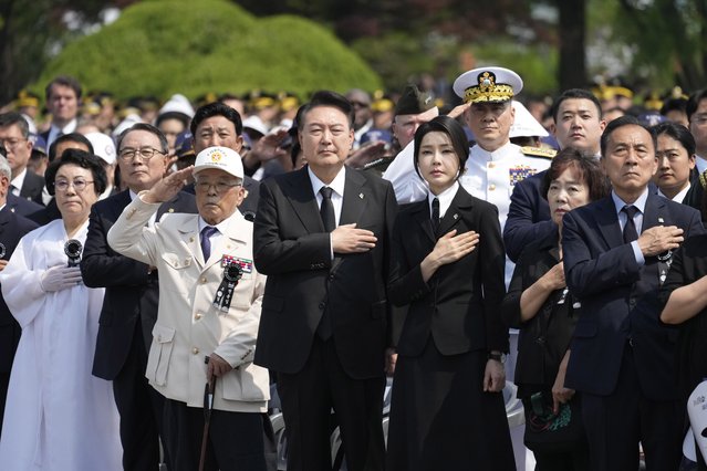 South Korean President Yoon Suk Yeol, center left, and his wife Kim Keon Hee, center right, salute during a ceremony to mark the 69th Memorial Day at the Seoul National Cemetery in Seoul, South Korea, Thursday, June 6, 2024. (Photo by Lee Jin-man/Pool via AP Photo)