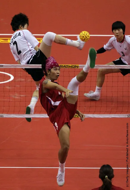 Sepaktakraw: Thailand's Daranee Charem hits a shot against South Korea's Kim I Seul during day two of the ISTAF Super Series at the Palembang Sport Convention Center