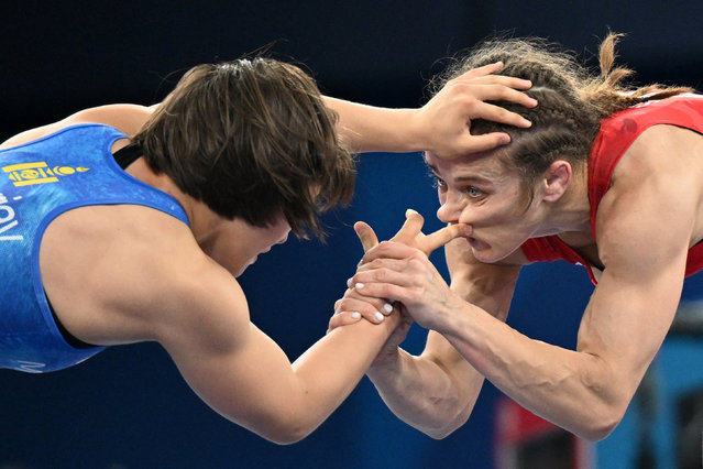 Azerbaijan's Mariya Stadnik (R) wrestles Mongolia's Otgonjargal Dolgorjav (L) in their women's freestyle 50kg wrestling quarter-final match at the Champ-de-Mars Arena during the Paris 2024 Olympic Games, in Paris on August 6, 2024. (Photo by Punit Paranjpe/AFP Photo)