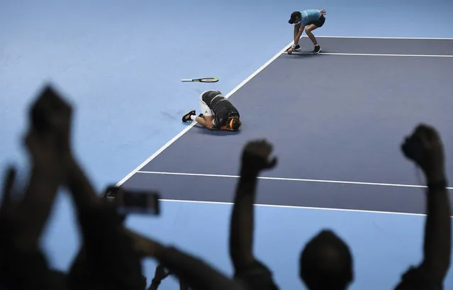 Stefanos Tsitsipas of Greece drops his racquet and drops to the ground as he wins and defeats Austria's Dominic Thiem their ATP World Finals singles final tennis match at the O2 arena in London, Sunday, November 17, 2019. (Photo by Alberto Pezzali/AP Photo)