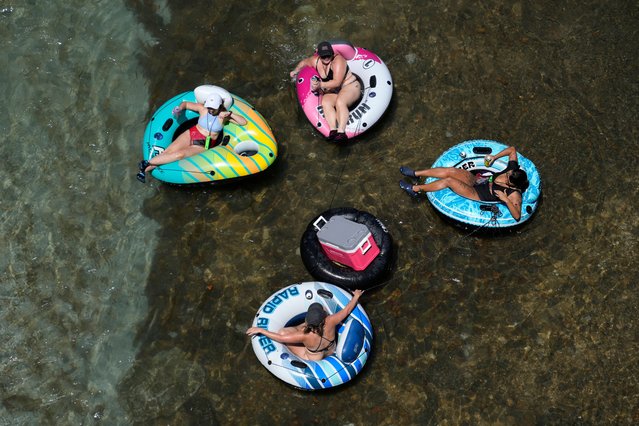 Tubers float the cool Comal River as temperatures in South Texas hit triple-digit numbers, Wednesday, August 21, 2024, in New Braunfels, Texas. (Photo by Eric Gay/AP Photo)