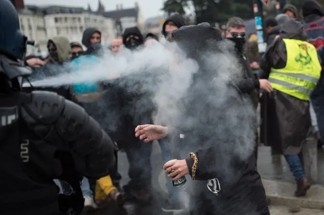 A woman reacts as tear gas is sprayed right into her face during a demonstration in Nantes on December 17, 2019 to protest against the French government's plan to overhaul the country's retirement system, as part of a national general strike. Tens of thousands of protesters prepared to hit streets across France on December 17, 2019 over a pensions overhaul that has sparked a crippling transport strike, though government officials insist they will not give in to union demands they drop the plan. Pressure on French President is growing after the top official overseeing the pension ne (Photo by Loic Venance/AFP Photo)