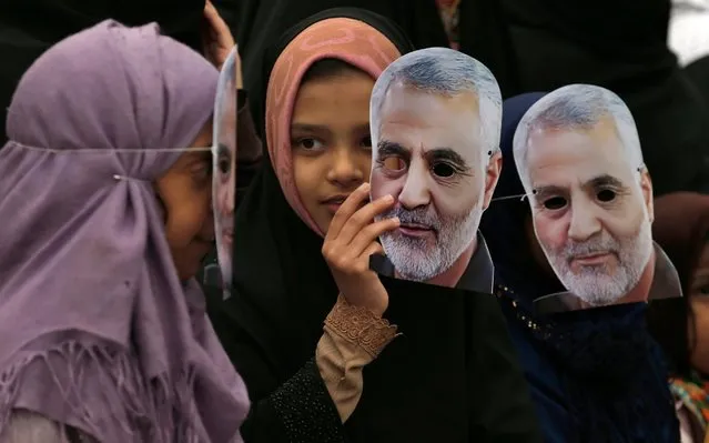 Pakistani Shiite Muslim girls hold masks of Iranian Revolutionary Guard Gen. Qassem Soleimani during a rally to condemn his killing by a U.S. airstrike in Iraq, in Islamabad, Pakistan, Sunday, January 5, 2020. Iran has vowed “harsh retaliation” for the U.S. airstrike near Baghdad's airport that killed Tehran's top general and the architect of its interventions across the Middle East, as tensions soared in the wake of the targeted killing. (Photo by Anjum Naveed/AP Photo)