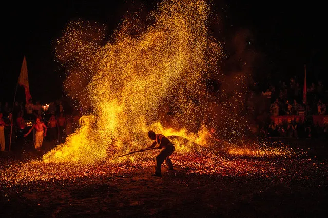 A barefooted man walks through burning charcoal as he performs “Lianhuo”, or “fire walking” to celebrate the Double Ninth Festival on October 7, 2019 in Jinhua, Zhejiang Province of China. Double Ninth Festival is celebrated on the ninth day of the ninth lunar month, which falls on October 7 this year. (Photo by Yang Meiqing/VCG via Getty Images)