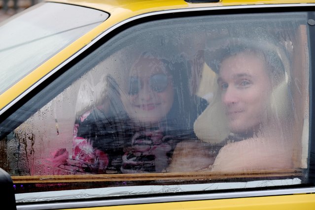 People react inside a car converted to sauna during the European Sauna Marathon in Otepaa, Estonia on February 15, 2020. (Photo by Ints Kalnins/Reuters)