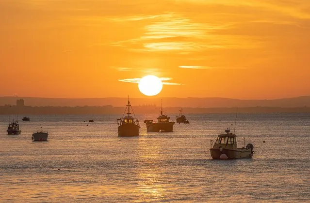 Picture dated June 12th, 2022 shows the sunrise over the English Channel seen from the beach in Selsey, West Sussex, on a sunny Sunday morning with a heatwave forecast for later in the week. (Photo by Coastal JJ/Bav Media)
