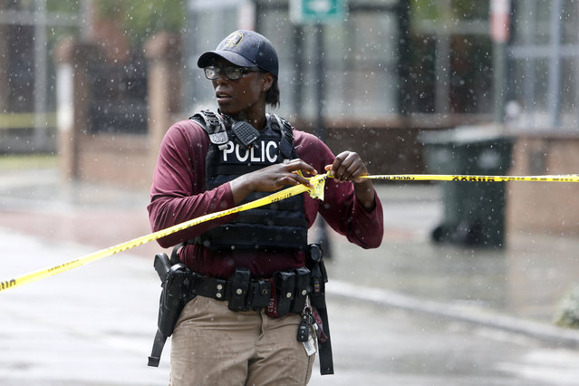 Charleston, S.C. Police Department blocks the street during an active hostage situation in Charleston, S.C., on Thursday, August 24, 2017.  Authorities say a disgruntled employee shot one person and is holding hostages in a restaurant in an area that is popular with tourists. Mayor John Tecklenburg said at a news conference that the shooting was not an act of terrorism or racism. (Photo by Mic Smith/AP Photo)