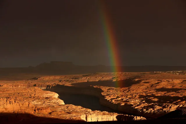 A rainbow hangs over Lake Powell on March 28, 2022 in Page, Arizona. As severe drought grips parts of the Western United States, water levels at Lake Powell dropped to their lowest level since the lake was created by the damming the Colorado River in 1963. Lake Powell is currently at 25 percent of capacity, a historic low, and has also lost at least 7 percent of its total capacity. The Colorado River Basin connects Lake Powell and Lake Mead and supplies water to 40 million people in seven western states. (Photo by Justin Sullivan/Getty Images)