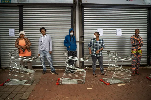 Residents of Yeoville neighborhood of Johannesburg, South Africa, wait in line to enter a grocery store Friday April 3, 2020. South Africa went into a nationwide lockdown for 21 days in an effort to control the spread of the coronavirus. (Photo by Jerome Delay/AP Photo)