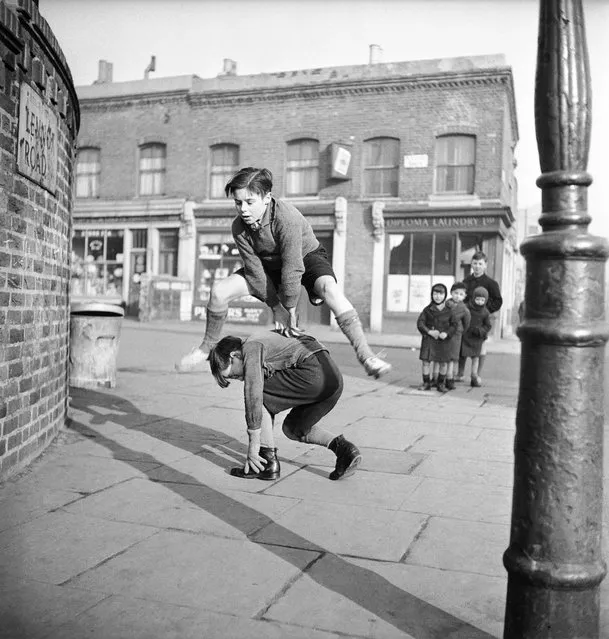 A group of children playing leap frog in the street, 1950.  (Photo by Bill Brandt)