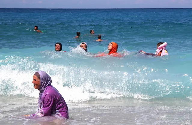 Albanian Muslim women refresh themselves in the waters of Ionian Sea near Saranda, Albania, 02 September 2015. Albania is under hot temperatures which reach 39 degrees Celsius, something not usual for this period of year. (Photo by Armando Babani/EPA)
