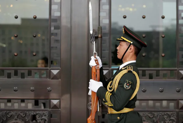A soldier from Chinese People's Liberation Army (PLA) stands guard at the Bayi Building in Beijing, China, July 25, 2016. (Photo by Jason Lee/Reuters)