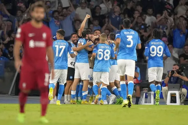 Napoli's team players celebrate after Piotr Zielinski scored their side's fourth goal during the group A Champions League soccer match between Napoli and Liverpool at the Diego Armando Maradona stadium in Naples, Italy, Wednesday, September 7, 2022. (Photo by Andrew Medichini/AP Photo)
