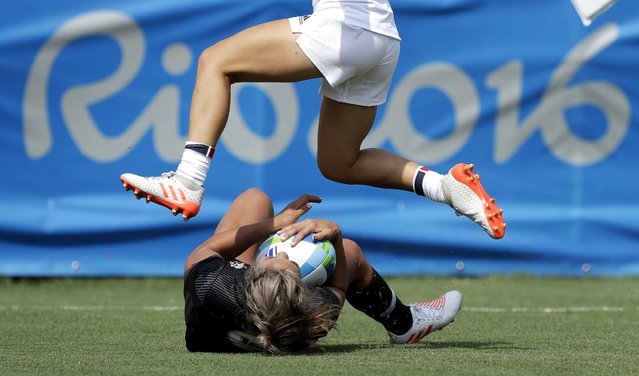 France's Pauline Biscarat, top, jumps over New Zealand's Huriana Manuel, after she scored a try during the women's rugby sevens match at the Summer Olympics in Rio de Janeiro, Brazil, Sunday, August 7, 2016. (Photo by Themba Hadebe/AP Photo)