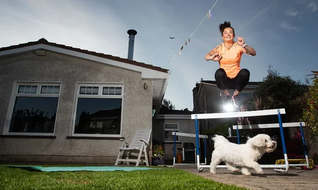 Irish athlete Ciara Neville exercises with her dog Minnie in Limerick, Ireland on May 19, 2020. (Photo by Tommy Dickson/INPHO/Rex Features/Shutterstock)