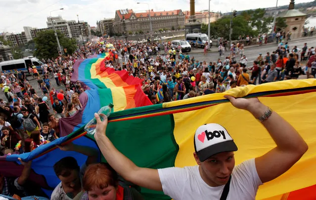 Participants hold a giant rainbow flag during the Prague Pride Parade where thousands marched through the city centre in support of gay rights, in Czech Republic, August 13, 2016. (Photo by David W. Cerny/Reuters)