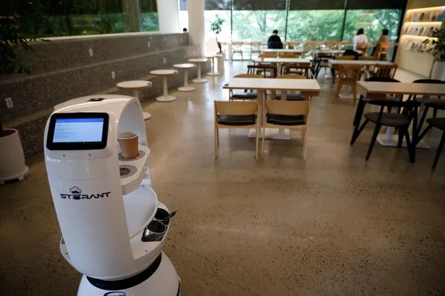 A robot that takes orders, makes coffee and brings the drinks straight to customers at their seats is seen at a cafe in Daejeon, South Korea, May 25, 2020. (Photo by Kim Hong-Ji/Reuters)