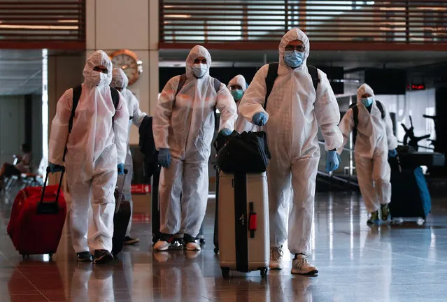 Seafarers who have spent the past months working onboard vessels arrive at the Changi Airport to board their flight back home to India during a crew change amid the coronavirus disease (COVID-19) outbreak in Singapore on June 12, 2020. (Photo by Edgar Su/Reuters)