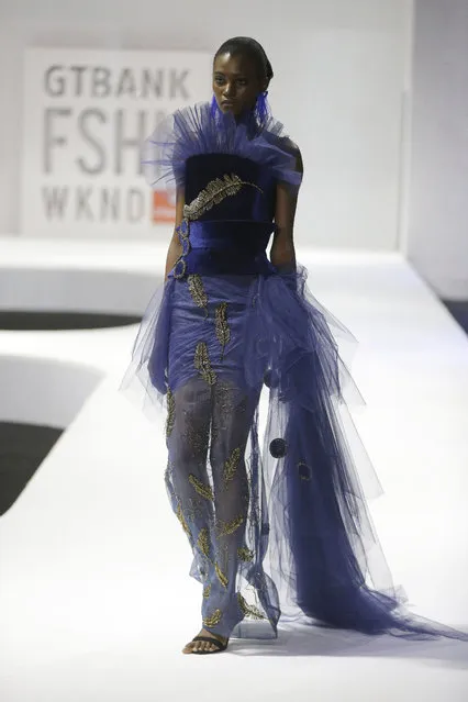A model displays creations by Weizdhurm Franklyn during the Fashion Week in Lagos, Nigeria, Sunday, November 12, 2017. (Photo by Sunday Alamba/AP Photo)