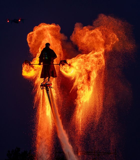 Folk artists perform by combining an intangible cultural heritage fire pot with the water flying man project at the Salt Lake scenic spot in Yuncheng, China, on January 31, 2025. (Photo by Costfoto/NurPhoto/Rex Features/Shutterstock)