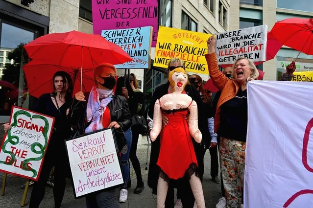 Sеx workers hold placards during a protest to demand the reopening of brothels amid the new coronavirus pandemic on July 3, 2020 near the Bundesrat (upper house of parliament) in Berlin. (Photo by John MacDougall/AFP Photo)