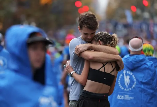 Felix Stiritz hugs girlfriend Kira Medish after she completed the marathon during the 2022 TCS New York City Marathon on November 06, 2022 in New York City. (Photo by Andrew Kelly/Reuters)