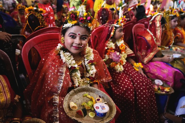 A young girl who is yet to attain puberty smiles as she dressed up as living goddesses before being worshipped as “kumari” or virgin during Bengali Hindu festival Basanti Durga Puja at a Kali temple in Adyapeath, India, Sunday, April 6, 2025. (Photo by Bikas Das/AP Photo)