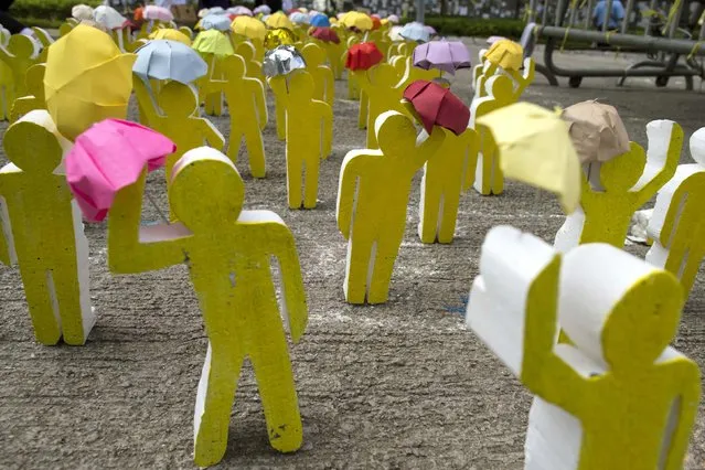 An art installation made from wood and paper depict the scene of Occupy Central protesters holding up their umbrellas outside the government headquarters in Hong Kong October 20, 2014. A deepening sense of impasse gripped Hong Kong on Monday as pro-democracy protests entered their fourth week, with the government having limited options to end the crisis and demonstrators increasingly willing to confront police. (Photo by Tyrone Siu/Reuters)