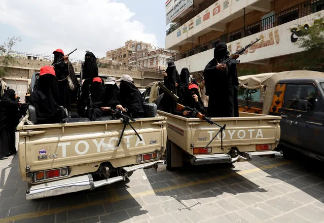 Armed women loyal to the Houthi movement ride on the back of trucks as they take part in a parade to show support for the movement in Sanaa, Yemen September 6, 2016. (Photo by Khaled Abdullah/Reuters)