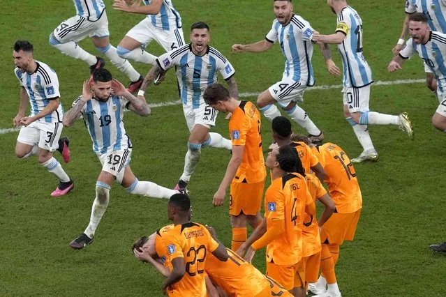 Argentina players celebrate at the end of the World Cup quarterfinal soccer match between the Netherlands and Argentina, at the Lusail Stadium in Lusail, Qatar, Saturday, December 10, 2022. (Photo by Thanassis Stavrakis/AP Photo)