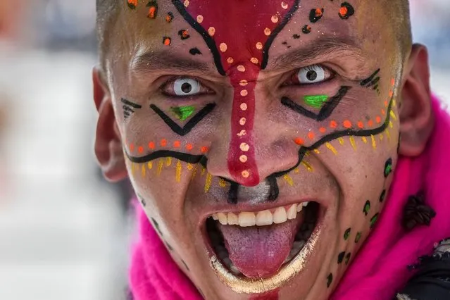 A reveller takes part in the “White Day” parade, on January 6, 2018, during the Carnival of Blacks and Whites in Pasto, Colombia, the largest festivity in the south-western region of the country. More than 10,000 people among artists, craftsmen and revellers take part in the Blacks and Whites Carnival, which has its origins in the mix of the multiple Andean, Amazonian and Pacific cultural expressions. It is celebrated every year from January 2 to 6 in the city of Pasto and is part of UNESCO's Intangible Cultural Heritage of Humanity since 2009. (Photo by Luis Robayo/AFP Photo)