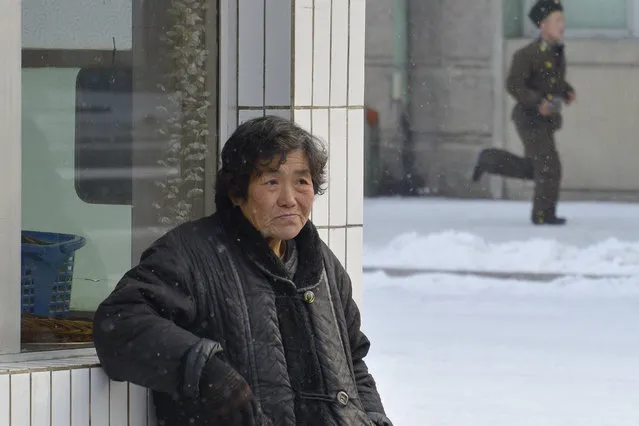 A resident of the capital stands outside a shop in February 2013, in Pyongyang, North Korea. (Photo by Andrew Macleod/Barcroft Media)