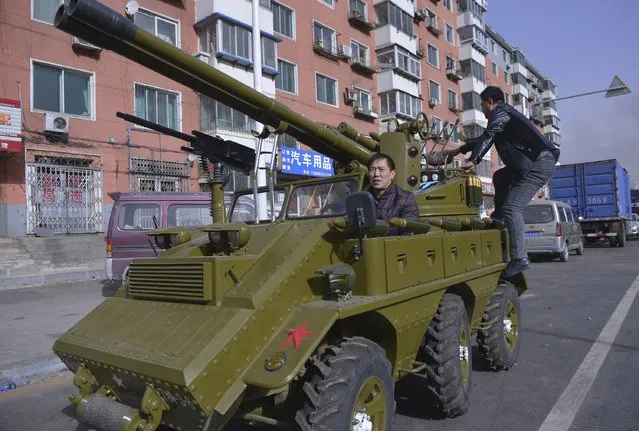 A man surnamed Zhang sits in his home-made armoured vehicle look-alike on a street in Shenyang, Liaoning province, November 12, 2014. (Photo by Reuters/Stringer)