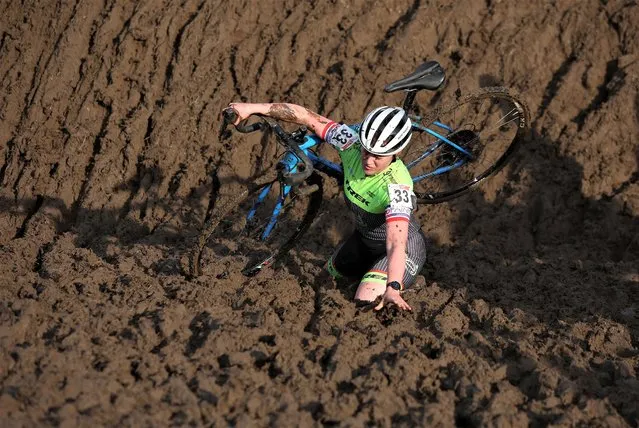 A competitor stumbles during the Junior women's race at the British Cyclocross championships near Milnthorpe, Britain on January 15, 2023. (Photo by Phil Noble/Reuters)
