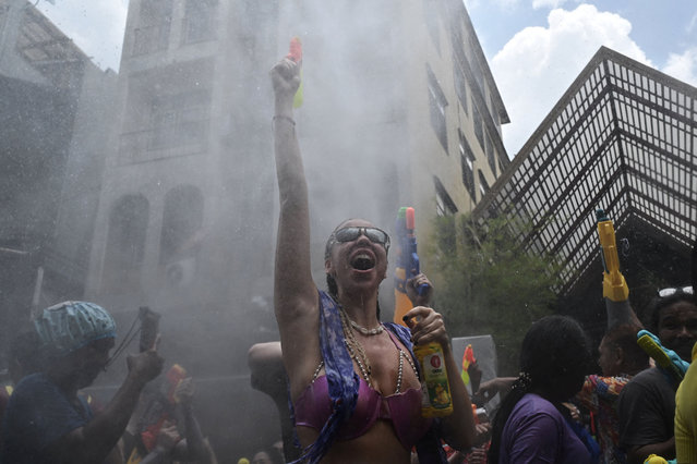Revellers take part in mass water fights on the first day of Songkran, or Thai New Year, on Khao San Road in Bangkok on April 13, 2025. (Photo by Lillian Suwanrumpha/AFP Photo)