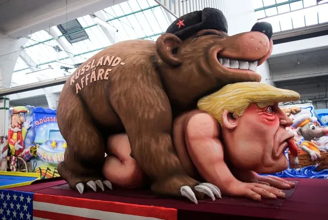 A carnival float, depicting a bear with the writing “Russia affair” on US President Donald Trump, is being prepared at a warehouse ahead of a carnival parade on Rose Monday on February 12, 2018 in Duesseldorf, southern Germany. (Photo by Marcel Kusch/Getty Images)