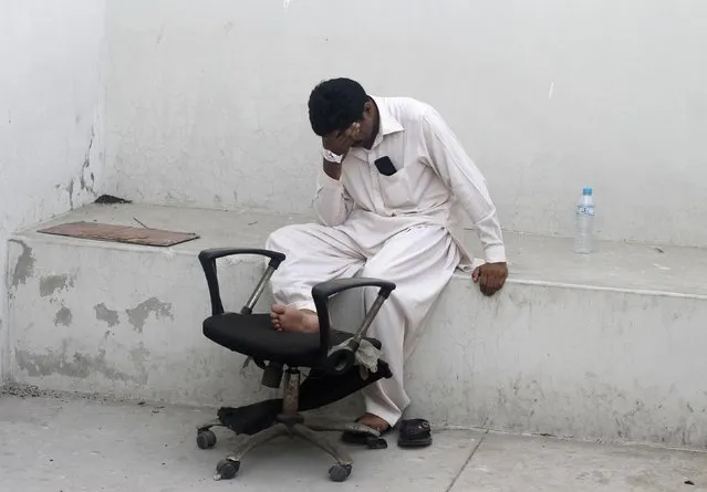 A man mourns the death of his relative, killed in Sunday's Taliban attack on Jinnah International Airport, outside a hospital morgue in Karachi, in this June 10, 2014 file photo. (Photo by Athar Hussain/Reuters)