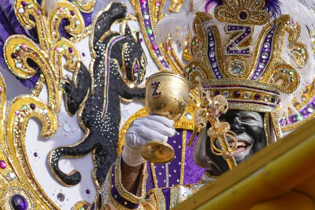 King of Zulu Nick Spears toasts from his float during the traditional Krewe of Zulu Parade on Mardi Gras Day in New Orleans, Tuesday, February 21, 2023. (Photo by Gerald Herbert/AP Photo)