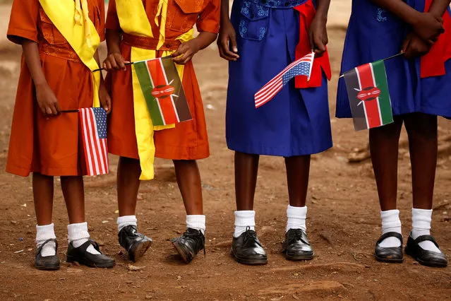 Young girls with U.S. and Kenya flags wait to greet U.S. Ambassador to Kenya Robert Godec as he visits a President's Emergency Plan for AIDS Relief (PEPFAR) project for girls' empowerment in Nairobi, Kenya, March 10, 2018. (Photo by Jonathan Ernst/Reuters)